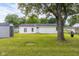 A sprawling backyard shows a white sided home with a tire swing hanging from a mature tree and a storage shed at 533 Patterson Rd, Columbus, IN 47203