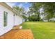 Home exterior and backyard features a wood tile patio, lush green grass and mature trees at 533 Patterson Rd, Columbus, IN 47203