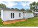 The backyard boasts a wood tile patio, healthy lawn and exterior view of the home at 533 Patterson Rd, Columbus, IN 47203