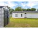This view shows a storage shed, green backyard and home exterior with a wood tile patio at 533 Patterson Rd, Columbus, IN 47203