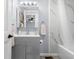 Bathroom features gray vanity, tiled shower, and medicine cabinet at 533 Patterson Rd, Columbus, IN 47203