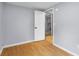 Bedroom has light gray walls, light colored floors, and an open doorway leading to another room at 533 Patterson Rd, Columbus, IN 47203