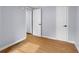 Bedroom features light gray walls, light colored floors, an open doorway, and a closed door at 533 Patterson Rd, Columbus, IN 47203