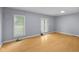 This bedroom has light gray walls, light colored flooring and two windows for natural light at 533 Patterson Rd, Columbus, IN 47203