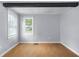 Bedroom with two windows providing natural light and laminate floors at 533 Patterson Rd, Columbus, IN 47203