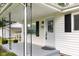 Inviting front porch leading to a charming entrance, enhanced by a well-lit exterior and manicured shrubs at 533 Patterson Rd, Columbus, IN 47203