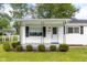 Charming front porch with manicured landscaping, enhancing curb appeal and providing a welcoming entrance at 533 Patterson Rd, Columbus, IN 47203