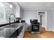 Modern kitchen featuring stainless steel appliances, a farmhouse sink, and sleek, modern fixtures at 533 Patterson Rd, Columbus, IN 47203