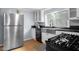 Updated kitchen featuring stainless steel appliances, white cabinets, and a large farmhouse sink at 533 Patterson Rd, Columbus, IN 47203