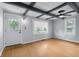 Bright living room features wood-look flooring, custom ceiling beams, and fresh light blue paint at 533 Patterson Rd, Columbus, IN 47203