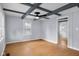 Cozy living area with wood-look floors, custom ceiling beams, and neutral walls at 533 Patterson Rd, Columbus, IN 47203