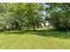 Large backyard showcasing mature trees and sprawling green space at 5719 N Frontage Rd, Fairland, IN 46126