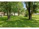 Picturesque backyard with mature trees offering a serene, private setting at 5719 N Frontage Rd, Fairland, IN 46126