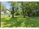 Expansive backyard with mature trees and lush green grass at 5719 N Frontage Rd, Fairland, IN 46126