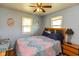 Cozy bedroom featuring two windows and a ceiling fan at 5719 N Frontage Rd, Fairland, IN 46126