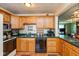 Galley kitchen with wood cabinets, stainless steel appliances, and breakfast nook at 5719 N Frontage Rd, Fairland, IN 46126