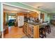 Open kitchen with wood cabinets, breakfast bar, and view into the living room at 5719 N Frontage Rd, Fairland, IN 46126