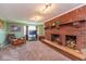 Cozy living room featuring a large brick fireplace and a comfortable seating area at 5719 N Frontage Rd, Fairland, IN 46126