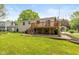 Exterior view of a home featuring a deck and a well manicured lawn at 5802 Rymark Ct, Indianapolis, IN 46250