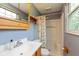 Bathroom with a shower and vanity, featuring natural light from a window at 5802 Rymark Ct, Indianapolis, IN 46250
