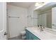 Bright bathroom with a blue vanity, white countertops, and updated fixtures at 5802 Rymark Ct, Indianapolis, IN 46250