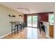 Bright dining area with hardwood floors, track lighting, and access to the outdoor deck at 5802 Rymark Ct, Indianapolis, IN 46250