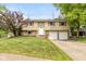 Charming two-story home features a manicured front lawn and attached two car garage at 5802 Rymark Ct, Indianapolis, IN 46250