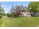 Two-story home features a well maintained yard and driveway leading to the attached garage at 5802 Rymark Ct, Indianapolis, IN 46250