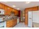 Efficient kitchen with granite countertops, tile backsplash, and bright lighting at 5802 Rymark Ct, Indianapolis, IN 46250