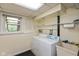 Practical laundry area with washer, dryer, and utility sink for added convenience at 5802 Rymark Ct, Indianapolis, IN 46250