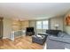 Cozy living room boasts hardwood floors, neutral paint, and an abundance of natural light at 5802 Rymark Ct, Indianapolis, IN 46250