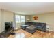 Comfortable living room with hardwood floors, large windows, and a comfortable sectional couch at 5802 Rymark Ct, Indianapolis, IN 46250