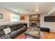 Cozy living room featuring a brick fireplace and comfortable seating area for relaxation at 5802 Rymark Ct, Indianapolis, IN 46250
