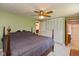 Spacious main bedroom featuring a ceiling fan, ensuite bathroom, and ample closet space at 5802 Rymark Ct, Indianapolis, IN 46250