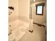 A bathroom featuring a large soaking tub, white tiled walls, and a frosted glass shower enclosure at 5943 Red Maple Dr, Indianapolis, IN 46237