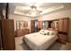 This bedroom features a neutral color scheme, ceiling fan, and a full wall of built-in drawers and storage at 5943 Red Maple Dr, Indianapolis, IN 46237