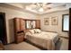 This bedroom has a neutral color scheme, a padded headboard with storage, and a ceiling fan at 5943 Red Maple Dr, Indianapolis, IN 46237