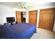 Cozy bedroom with plush carpeting, ample closet space, and a comfortable blue bedspread at 5943 Red Maple Dr, Indianapolis, IN 46237