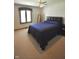 Comfortable bedroom with a large window, ceiling fan, and plush carpet at 5943 Red Maple Dr, Indianapolis, IN 46237