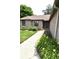 Landscaped walkway leading to the home's entrance, adorned with vibrant flowers and lush greenery at 5943 Red Maple Dr, Indianapolis, IN 46237
