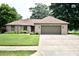 Charming brick home with a well-maintained lawn and inviting curb appeal in a tranquil neighborhood at 5943 Red Maple Dr, Indianapolis, IN 46237