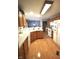 Kitchen featuring wood floors and cabinets, white appliances, and plenty of counter space at 5943 Red Maple Dr, Indianapolis, IN 46237