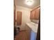 Convenient laundry room with washer, dryer, and built-in cabinets for storage at 5943 Red Maple Dr, Indianapolis, IN 46237