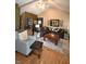 Vaulted living room featuring a dark sectional couch, wood floors, and light gray arm chair with matching ottoman at 5943 Red Maple Dr, Indianapolis, IN 46237