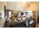Spacious living room with vaulted ceilings, a brick fireplace, wood floors, and lots of natural light at 5943 Red Maple Dr, Indianapolis, IN 46237
