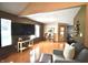 An open living space offering wood floors, vaulted ceilings, with a large flat screen tv and lots of natural light at 5943 Red Maple Dr, Indianapolis, IN 46237