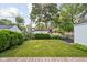 A large, green backyard, partially visible from a wooden deck, provides ample space for outdoor activities and gardening at 6045 Crittenden Ave, Indianapolis, IN 46220