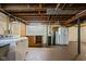 Spacious unfinished basement with washer/dryer and vintage refrigerator at 6045 Crittenden Ave, Indianapolis, IN 46220