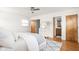 Nicely appointed bedroom with ceiling fan, hardwood floors, and ensuite access at 6045 Crittenden Ave, Indianapolis, IN 46220