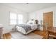 Bright bedroom with hardwood floors, natural light, and stylish, neutral decor at 6045 Crittenden Ave, Indianapolis, IN 46220